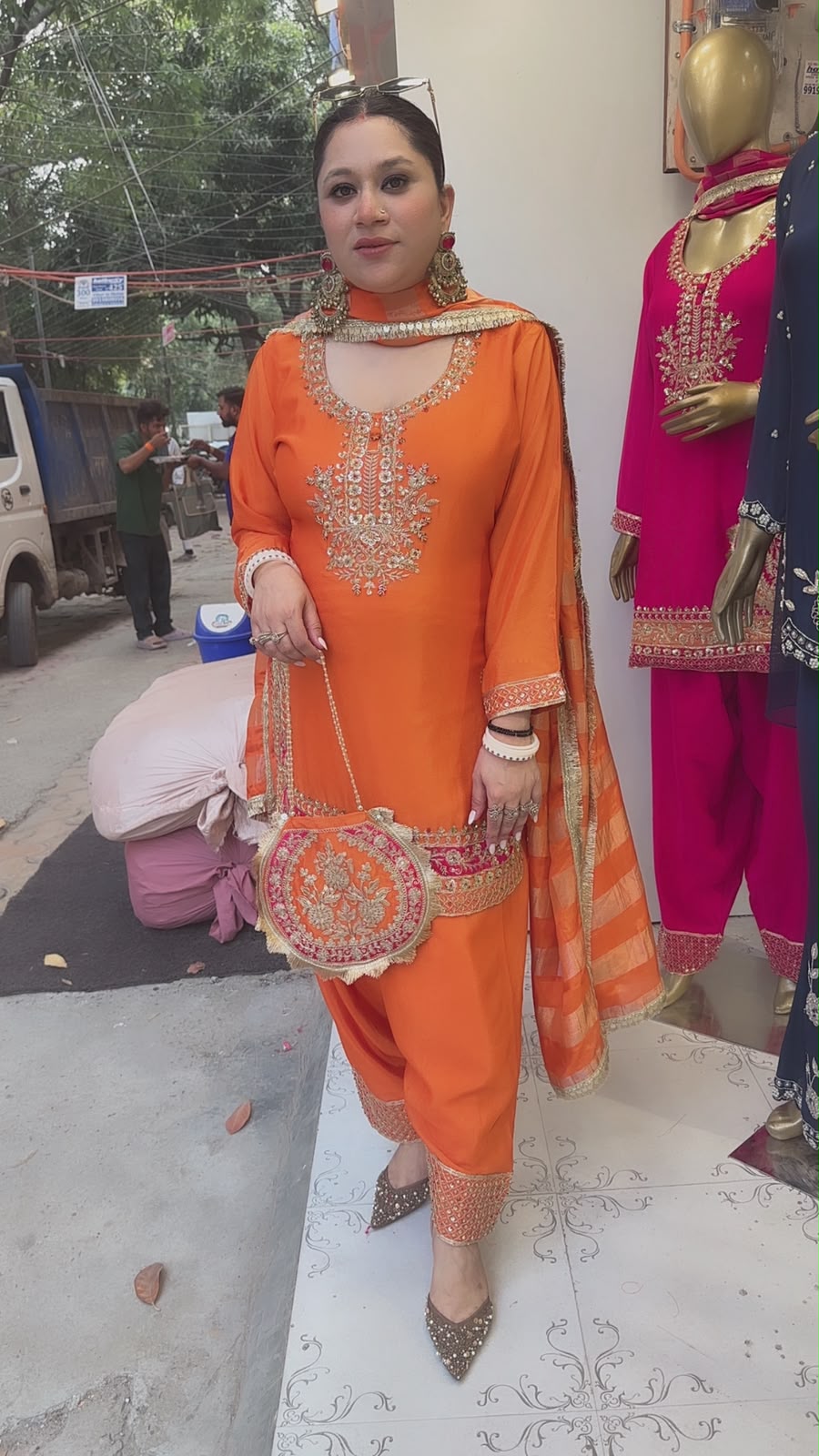 Biwi Rust Orange Embroidered Designer Suit with potli