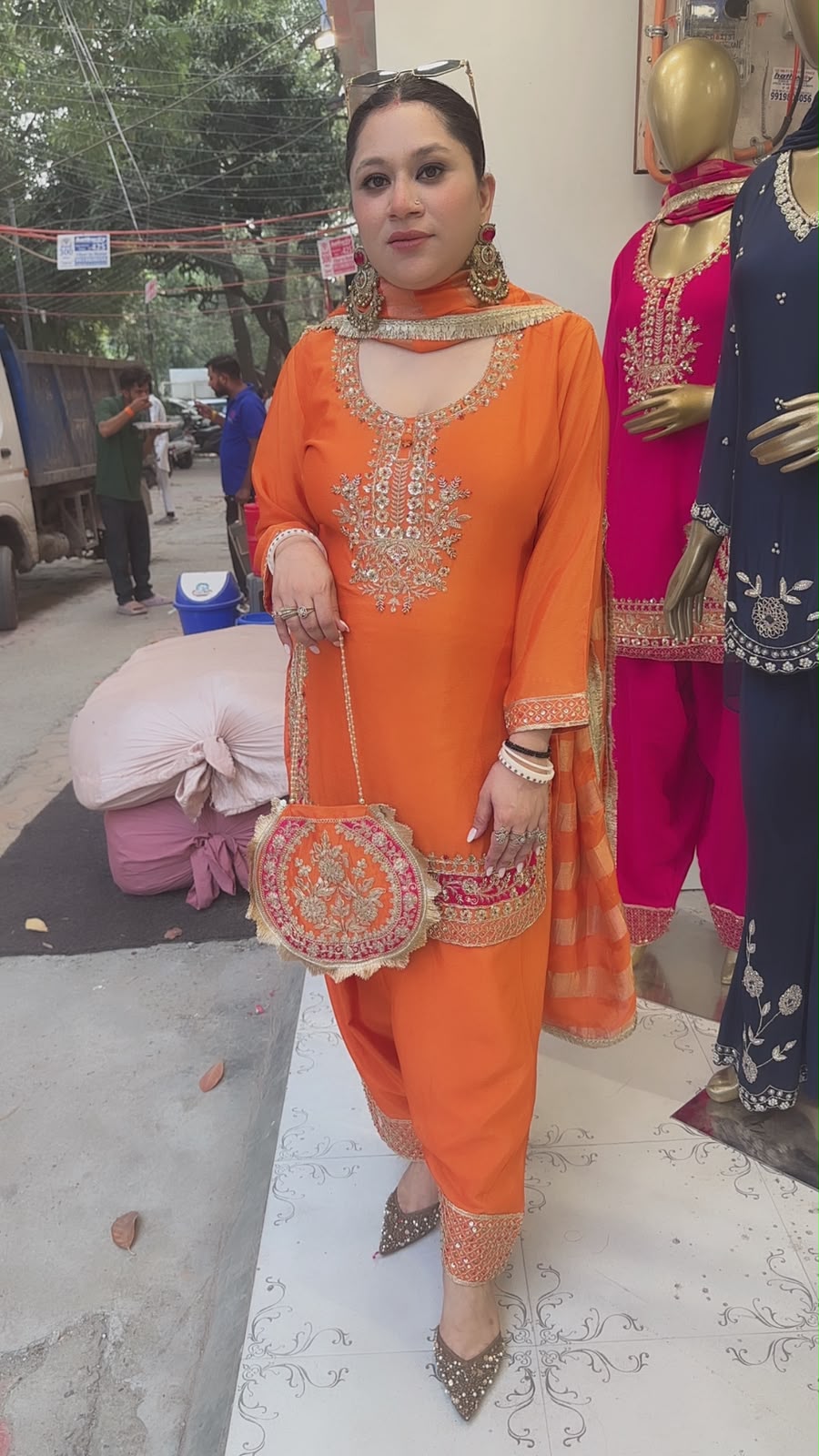 Biwi Rust Orange Embroidered Designer Suit with potli