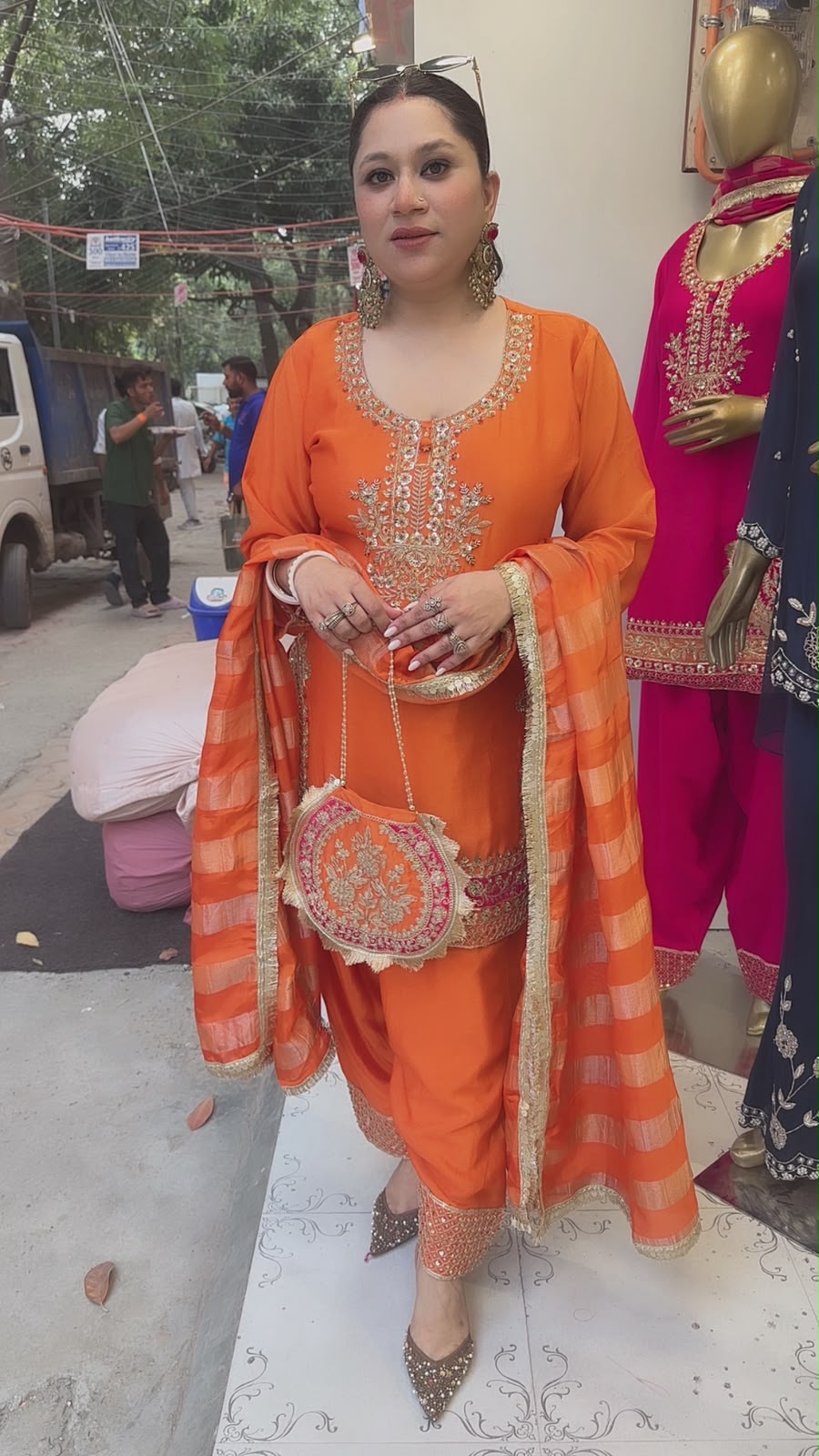 Biwi Rust Orange Embroidered Designer Suit with potli
