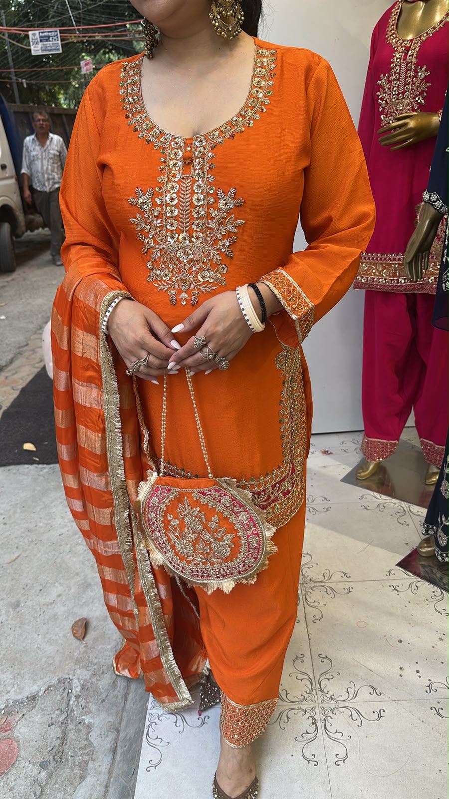 Biwi Rust Orange Embroidered Designer Suit with potli